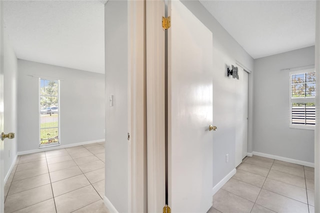 corridor featuring light tile patterned floors