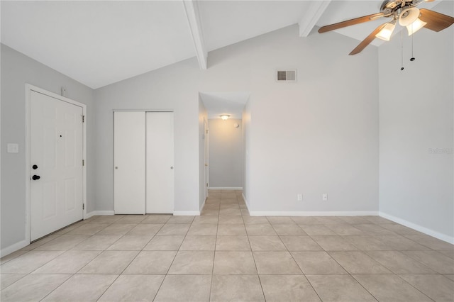 interior space with vaulted ceiling with beams, ceiling fan, and light tile patterned floors