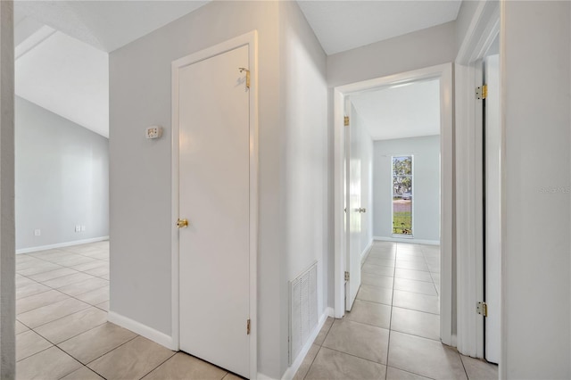 hall featuring light tile patterned flooring