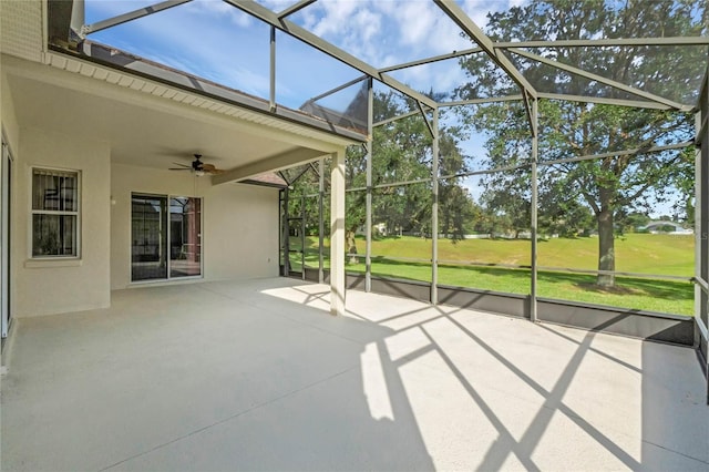 unfurnished sunroom with ceiling fan