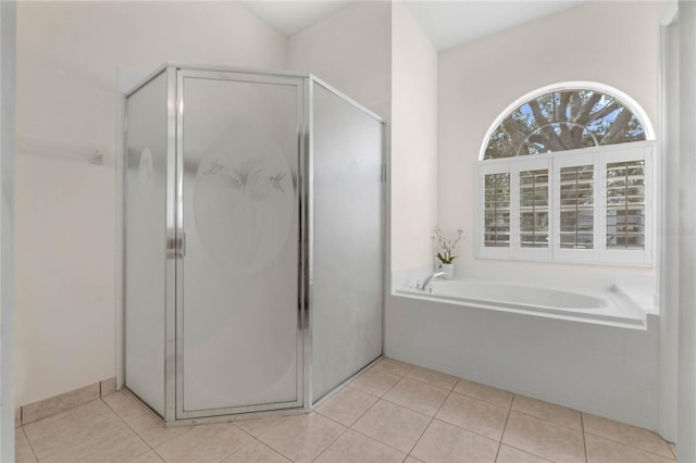 bathroom featuring tile patterned floors and separate shower and tub