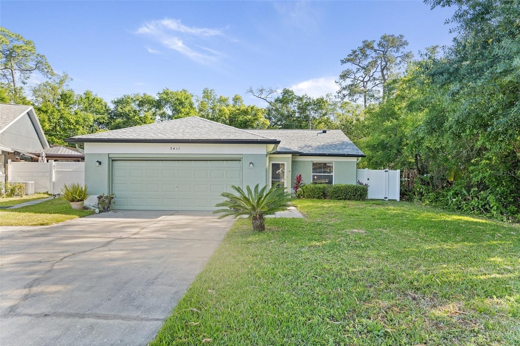 view of front of home with a garage and a front lawn