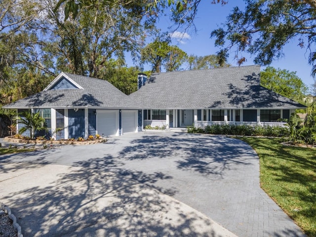 view of front of home with a garage and a front lawn