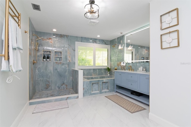 bathroom featuring vanity and tiled shower