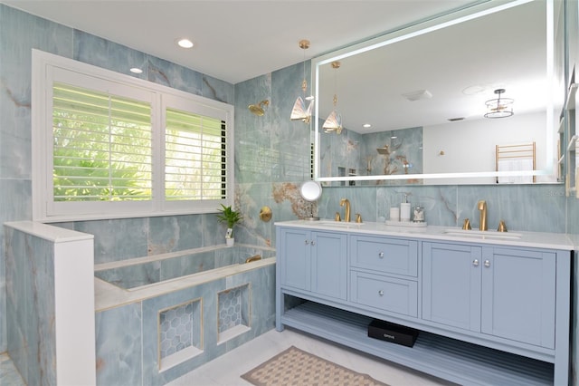 bathroom featuring tile walls, tile patterned flooring, and vanity