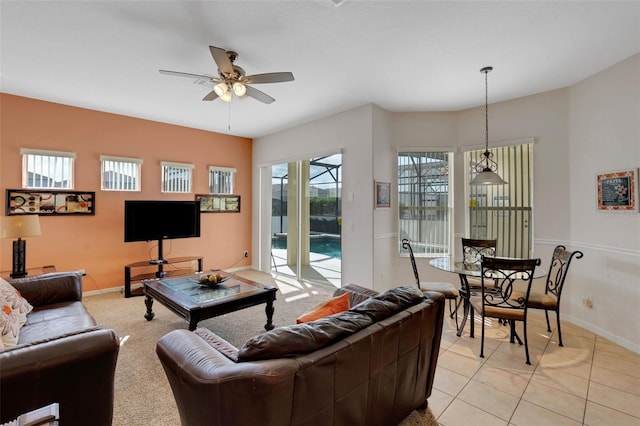 living room featuring ceiling fan and light tile patterned floors