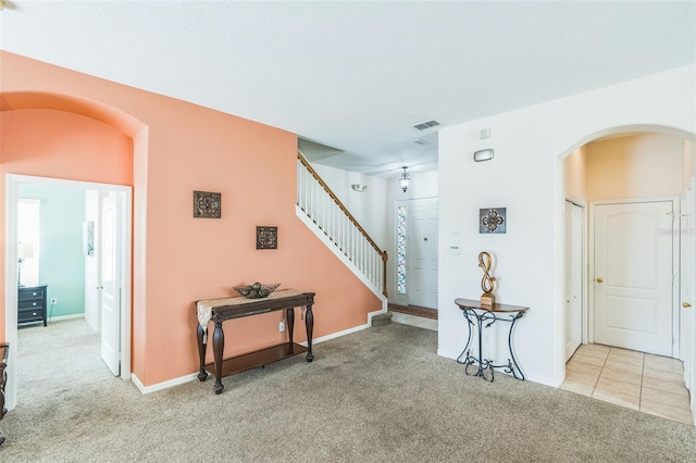 hall featuring light colored carpet