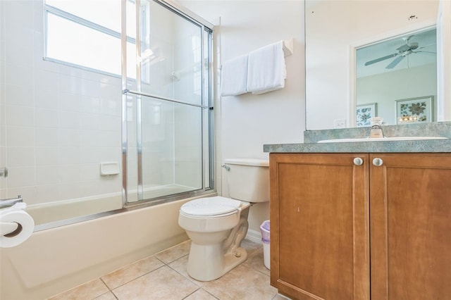 full bathroom featuring vanity, bath / shower combo with glass door, tile patterned flooring, toilet, and ceiling fan