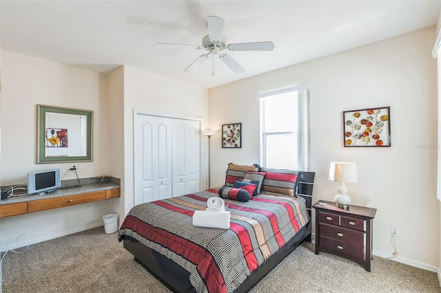 carpeted bedroom with a closet and ceiling fan