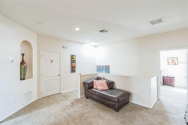 sitting room featuring light colored carpet