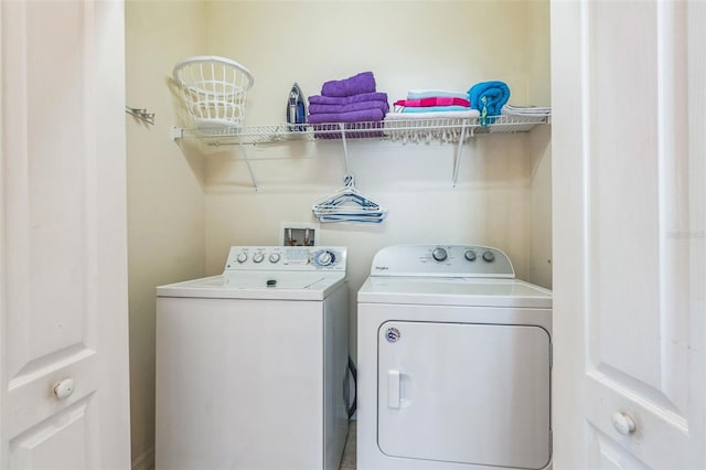 washroom featuring washing machine and dryer