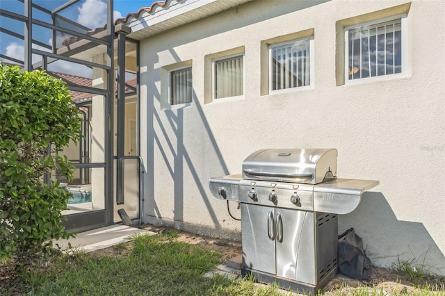 view of patio featuring a lanai and area for grilling