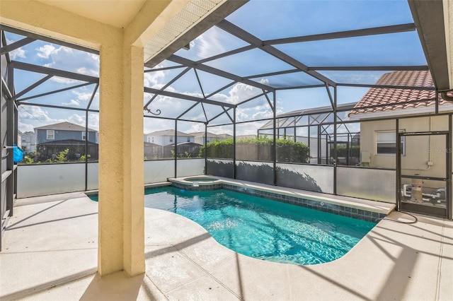 view of swimming pool with a lanai, an in ground hot tub, and a patio area