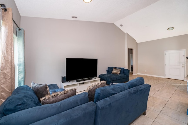 living room with light tile patterned floors and vaulted ceiling