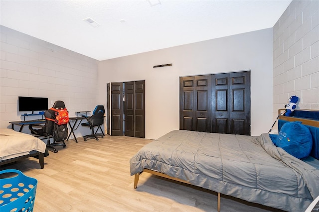 bedroom with hardwood / wood-style flooring