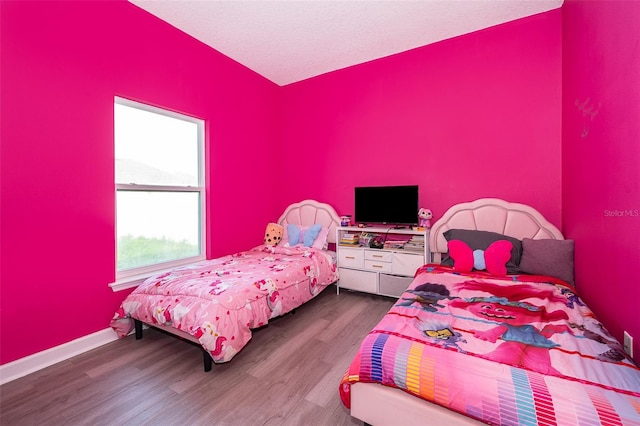 bedroom featuring hardwood / wood-style floors and a textured ceiling