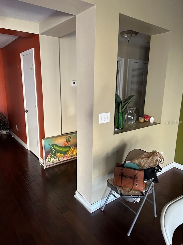 corridor with dark hardwood / wood-style floors