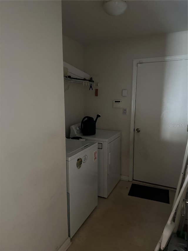 clothes washing area featuring separate washer and dryer