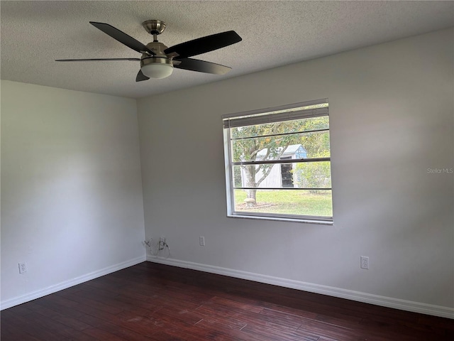 spare room with ceiling fan, a textured ceiling, and dark hardwood / wood-style flooring