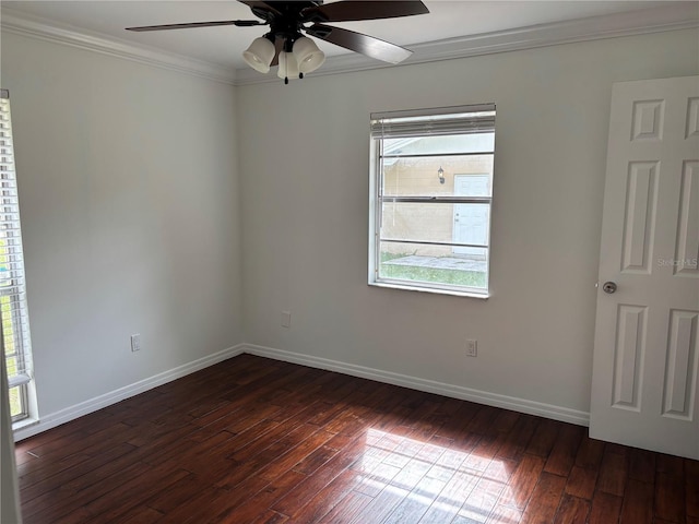 empty room with a wealth of natural light, dark wood-type flooring, ceiling fan, and crown molding