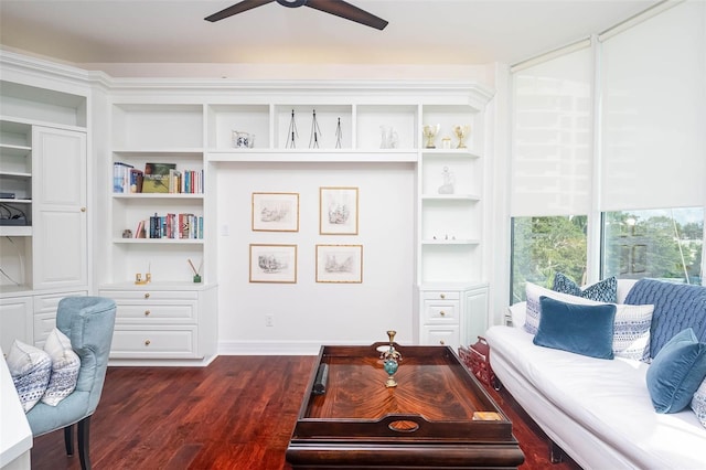 living room with ceiling fan and dark wood-type flooring