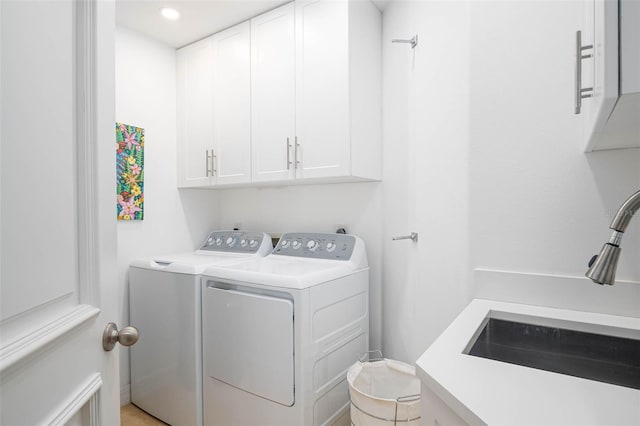 340 S Palm Ave Unit 11, Sarasota, FL 34236 - washroom featuring cabinet space, separate washer and dryer, and recessed lighting