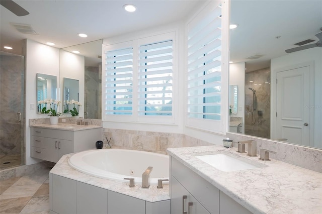 bathroom featuring ceiling fan, vanity, and independent shower and bath