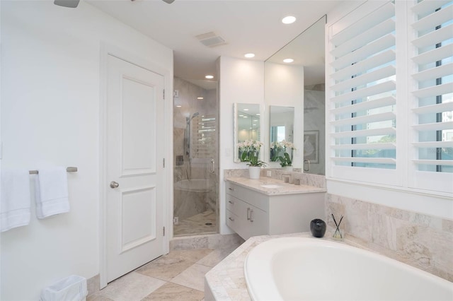 340 S Palm Ave Unit 11, Sarasota, FL 34236 - bathroom featuring vanity, a garden tub, a shower stall, and recessed lighting