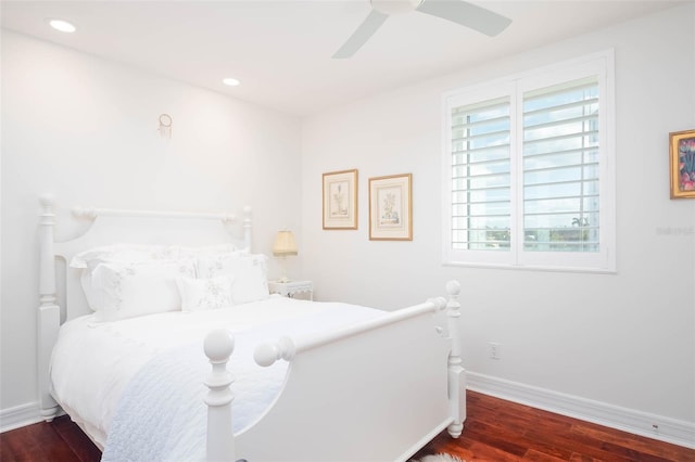 bedroom with ceiling fan and dark wood-type flooring