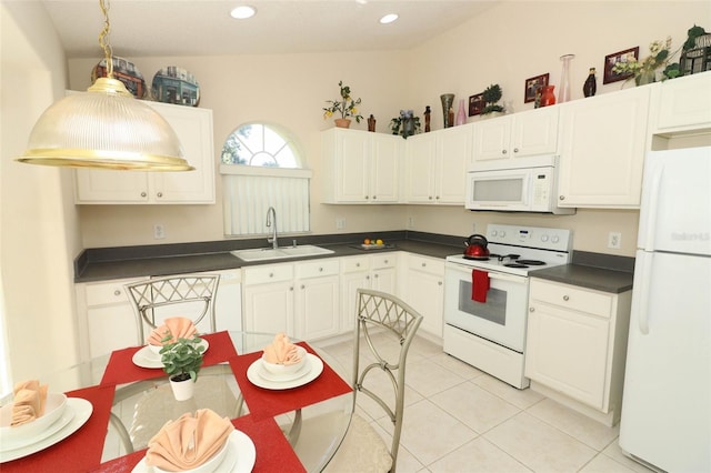 kitchen featuring lofted ceiling, white cabinets, sink, light tile patterned flooring, and white appliances