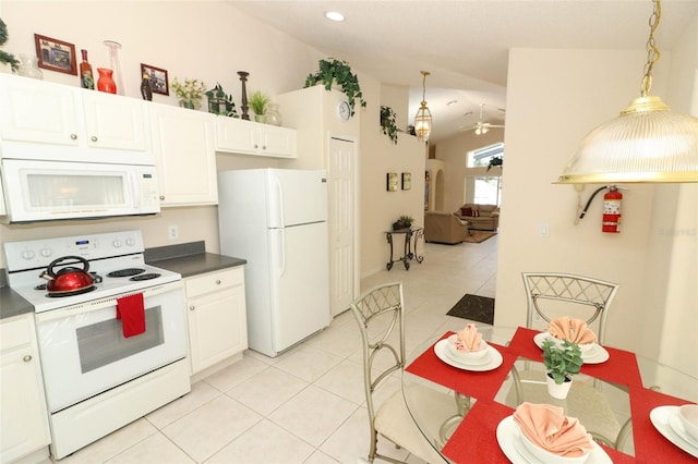 kitchen with hanging light fixtures, vaulted ceiling, white cabinets, white appliances, and ceiling fan