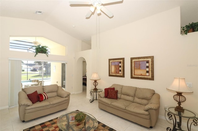 tiled living room with lofted ceiling and ceiling fan