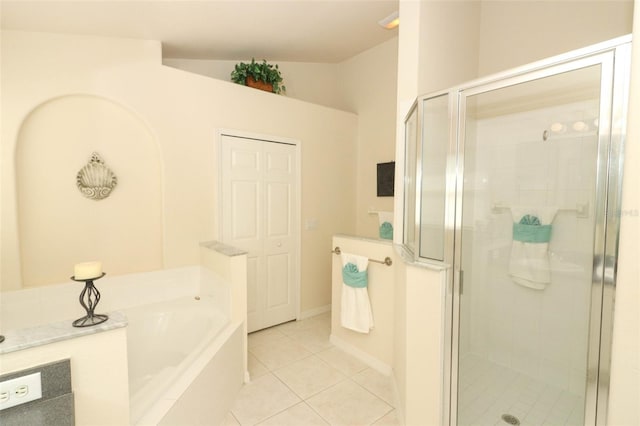 bathroom featuring plus walk in shower, vaulted ceiling, and tile patterned floors