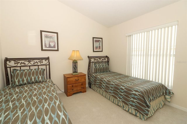 carpeted bedroom with vaulted ceiling