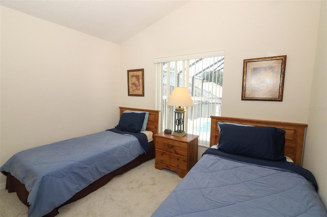 carpeted bedroom with lofted ceiling