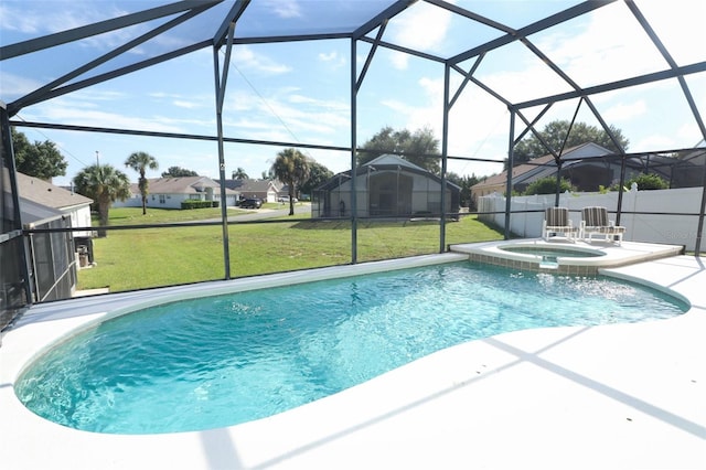 view of pool featuring a patio, a yard, an in ground hot tub, and glass enclosure