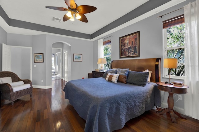 bedroom with ceiling fan and dark hardwood / wood-style flooring