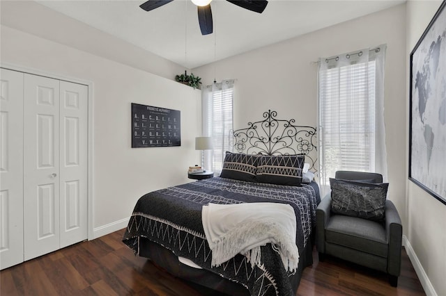 bedroom with dark hardwood / wood-style flooring, a closet, multiple windows, and ceiling fan