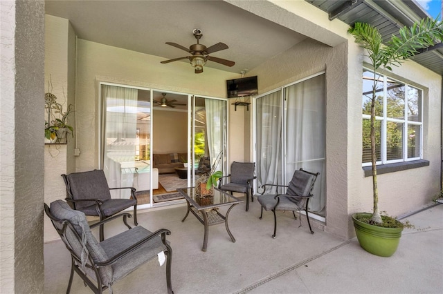 view of patio featuring ceiling fan