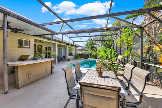 view of patio with an outdoor kitchen and ceiling fan