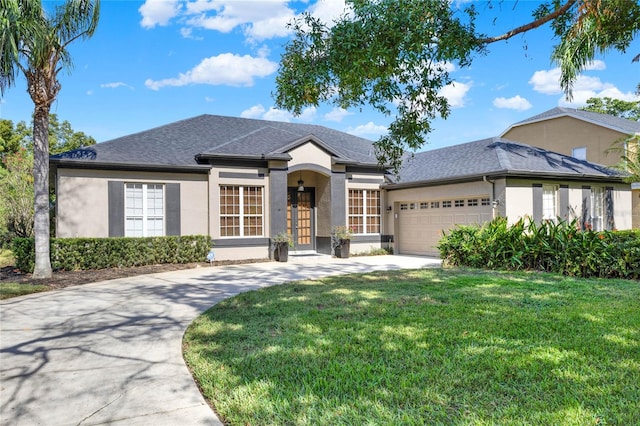 view of front of property with a garage and a front yard