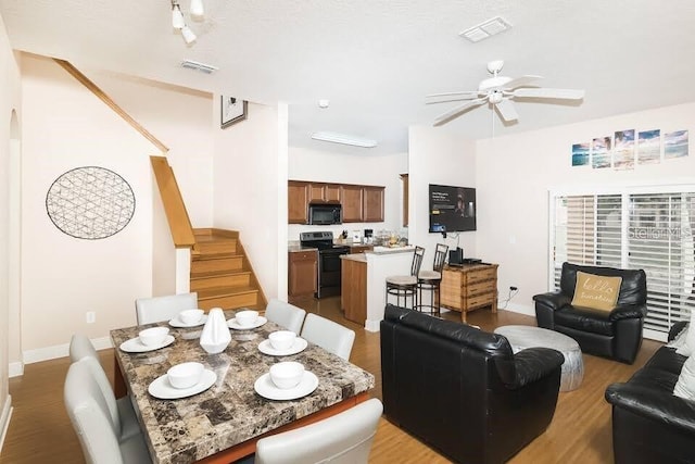 dining area featuring light hardwood / wood-style floors and ceiling fan