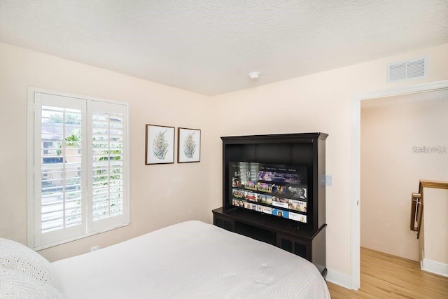 bedroom with light hardwood / wood-style flooring