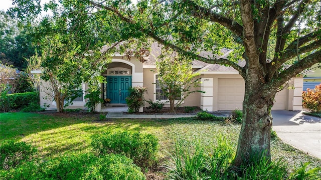 view of front of property with a garage and a front yard