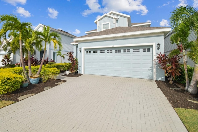 307 Shore Crab Way, Apollo Beach, FL 33572 - view of front of house with decorative driveway, a garage, and stucco siding