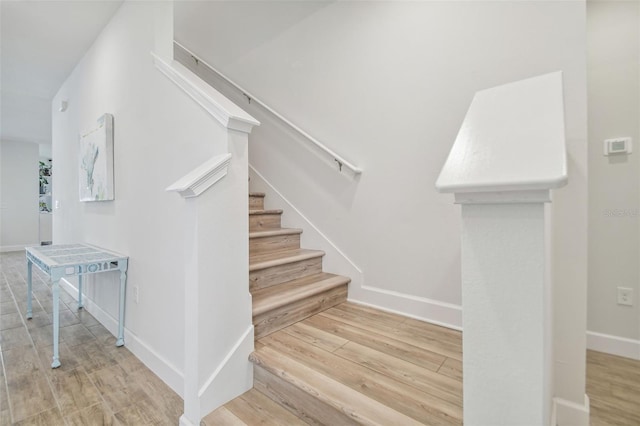 stairs with hardwood / wood-style flooring