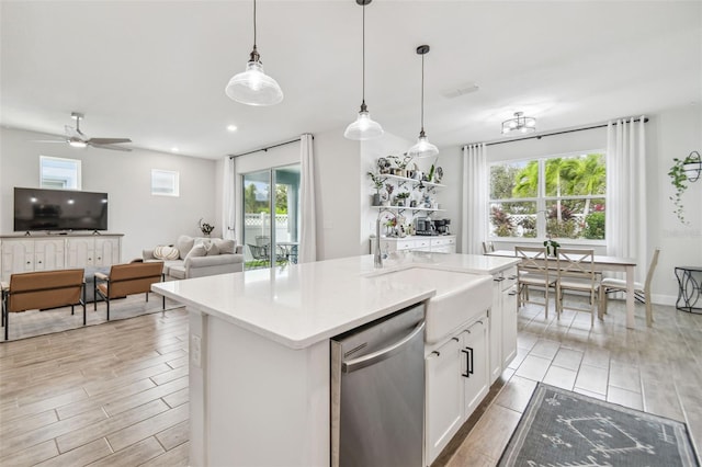 kitchen with white cabinetry, a healthy amount of sunlight, a kitchen island with sink, and dishwasher