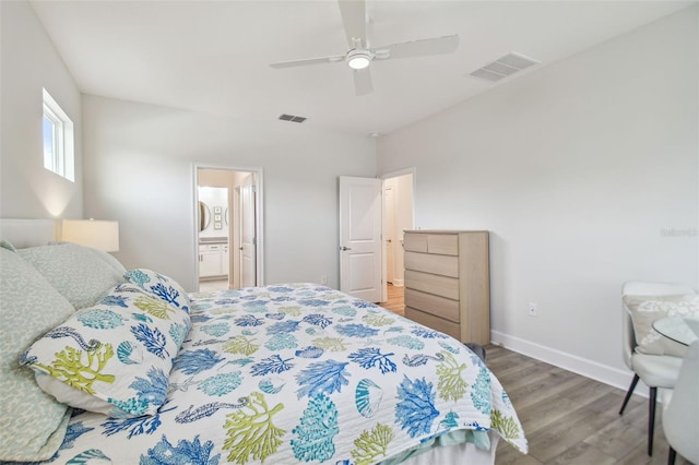 bedroom featuring ensuite bath, wood-type flooring, and ceiling fan