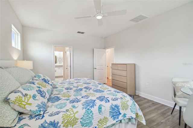 307 Shore Crab Way, Apollo Beach, FL 33572 - bedroom with wood finished floors, baseboards, a ceiling fan, and ensuite bath
