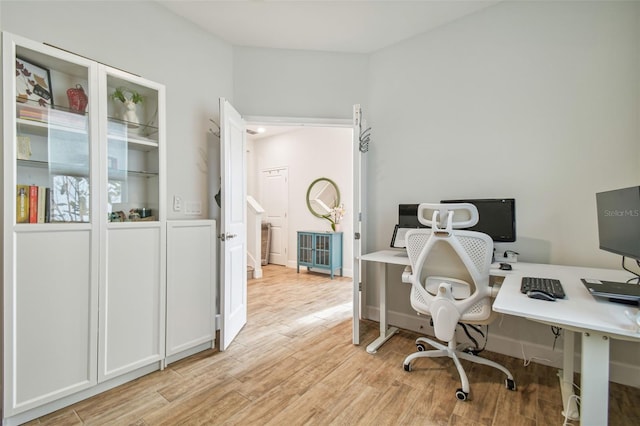 office with light wood-type flooring